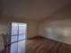 Living area with hardwood floors and sliding glass doors to patio at 2672 Arjay Ct, Palm Harbor, FL 34684