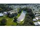 Aerial view of a mobile home community with a central lake at 36651 Jodi Ave, Zephyrhills, FL 33542