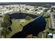 Aerial view of community with pond and fountain at 36651 Jodi Ave, Zephyrhills, FL 33542