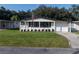 Single story home with a carport and American flag at 36651 Jodi Ave, Zephyrhills, FL 33542