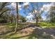 Landscaped front yard with mature trees and a paved driveway leading to the house at 505 S 56Th St, Tampa, FL 33619