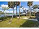 Landscaped backyard with palm trees and waterfront access at 505 S 56Th St, Tampa, FL 33619