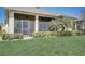 Relaxing screened patio with ceiling fans and lush landscaping at 1804 Pacific Dunes Dr, Sun City Center, FL 33573