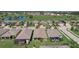 Aerial view of a community with houses and a golf course at 1804 Pacific Dunes Dr, Sun City Center, FL 33573