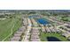 Aerial view of community featuring a pond, golf course and houses at 1804 Pacific Dunes Dr, Sun City Center, FL 33573