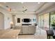 Open concept living area with a view into the kitchen and access to the patio at 1804 Pacific Dunes Dr, Sun City Center, FL 33573