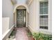 Inviting entryway with a brick walkway and a dark gray front door at 1804 Pacific Dunes Dr, Sun City Center, FL 33573