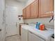 Convenient laundry room with washer, dryer, and cabinets at 1804 Pacific Dunes Dr, Sun City Center, FL 33573