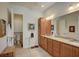Bathroom with dual vanity, granite countertops, and separate toilet area at 1804 Pacific Dunes Dr, Sun City Center, FL 33573