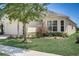 Tan house with bay window, landscaping, and brick walkway at 1804 Pacific Dunes Dr, Sun City Center, FL 33573