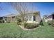 Home's backyard features a well-manicured lawn and lush landscaping at 1804 Pacific Dunes Dr, Sun City Center, FL 33573
