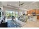 Open living area with a view of the kitchen and access to a backyard patio at 1804 Pacific Dunes Dr, Sun City Center, FL 33573
