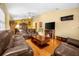 Living room with brown leather furniture and wood floors at 6703 Pistachio St, Zephyrhills, FL 33542