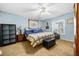 Cozy bedroom with plush carpet, ceiling fan, and ample closet space at 6703 Pistachio St, Zephyrhills, FL 33542