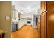 Galley kitchen with white appliances, ample cabinet space, and wood floors at 6703 Pistachio St, Zephyrhills, FL 33542