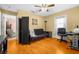 Home office features built-in desk, sofabed, and wood flooring at 6703 Pistachio St, Zephyrhills, FL 33542