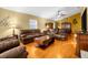 Spacious living room with brown couches and a fireplace at 6703 Pistachio St, Zephyrhills, FL 33542