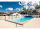 Community pool with surrounding patio and lounge chairs at 6703 Pistachio St, Zephyrhills, FL 33542