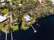 Aerial view of waterfront home with private dock and lush landscaping at 505 S 56Th St, Tampa, FL 33619