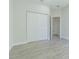 Simple bedroom with double door closet and wood-look floors at 2010 1/2 E Wood St # St, Tampa, FL 33604