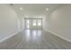 Spacious living room with wood-look flooring and neutral walls at 2010 1/2 E Wood St # St, Tampa, FL 33604