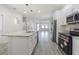 Open concept kitchen featuring granite island and stainless steel appliances at 2010 1/2 E Wood St # St, Tampa, FL 33604