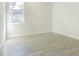 Well-lit bedroom with wood-look floors and window at 2010 1/2 E Wood St # St, Tampa, FL 33604