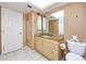 Bathroom vanity with granite countertop and storage, next to a toilet at 2390 Shelly Dr # D, Palm Harbor, FL 34684