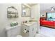 Bathroom with white vanity and fixtures, adjoining the bedroom at 2390 Shelly Dr # D, Palm Harbor, FL 34684