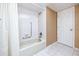 Cozy bathroom featuring a shower and tub, a tiled interior, and neutral color scheme at 2390 Shelly Dr # D, Palm Harbor, FL 34684