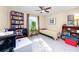 Inviting bedroom with natural light, tile flooring, ceiling fan, and built-in bookshelf at 2390 Shelly Dr # D, Palm Harbor, FL 34684