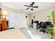 Comfortable bedroom featuring tile flooring, ceiling fan, ample closet space, and a workspace at 2390 Shelly Dr # D, Palm Harbor, FL 34684