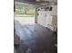 Spacious garage with an open door, concrete flooring, and ample storage space, ideal for parking and projects at 2390 Shelly Dr # D, Palm Harbor, FL 34684