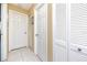 Hallway featuring tile floors, neutral paint and white doors with hardware at 2390 Shelly Dr # D, Palm Harbor, FL 34684