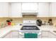 Well-lit kitchen featuring white cabinetry, countertops, and modern appliances at 2390 Shelly Dr # D, Palm Harbor, FL 34684