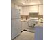 Clean kitchen featuring white appliances and ample counter space at 2390 Shelly Dr # D, Palm Harbor, FL 34684