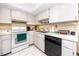 Functional kitchen featuring a stove, dishwasher, and white cabinets at 2390 Shelly Dr # D, Palm Harbor, FL 34684