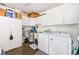Functional laundry area with white cabinets, washer, dryer, utility sink and water heater for convenience at 2390 Shelly Dr # D, Palm Harbor, FL 34684