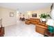 Comfortable living room with tile floors, ceiling fan, dining area, and leather furniture at 2390 Shelly Dr # D, Palm Harbor, FL 34684