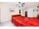 Bright bedroom featuring a ceiling fan, tile flooring and neutral color palette at 2390 Shelly Dr # D, Palm Harbor, FL 34684
