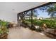 Screened porch offering serene outdoor views, tiled floors and landscaping at 2390 Shelly Dr # D, Palm Harbor, FL 34684