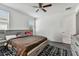 Spacious bedroom with a brown comforter and ceiling fan at 32176 Rosewood Meadow Ln, Wesley Chapel, FL 33543