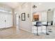 Inviting foyer featuring a breakfast bar with barstools, tiled floors, and a view into the kitchen at 4538 Pointe O Woods Dr, Wesley Chapel, FL 33543