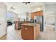 Open-concept kitchen flowing into the living area, with modern appliances and a breakfast bar at 4538 Pointe O Woods Dr, Wesley Chapel, FL 33543