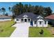 Two-story house with gray siding and paver driveway at 4748 Hickory Oak Dr, Brooksville, FL 34601
