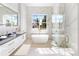 Luxurious bathroom with soaking tub, walk-in shower, and marble finishes at 4748 Hickory Oak Dr, Brooksville, FL 34601