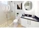 Modern bathroom with a walk-in shower, toilet, and vanity with a large mirror at 4748 Hickory Oak Dr, Brooksville, FL 34601
