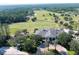 Aerial view of clubhouse with palm trees and golf course in background at 4748 Hickory Oak Dr, Brooksville, FL 34601