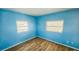 Inviting bedroom features wood-look floors, fresh paint, and windows to let in natural light at 527 4Th Nw Ave, Largo, FL 33770