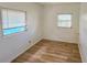 Bedroom with light wood laminate floors and bright natural light at 527 4Th Nw Ave, Largo, FL 33770
